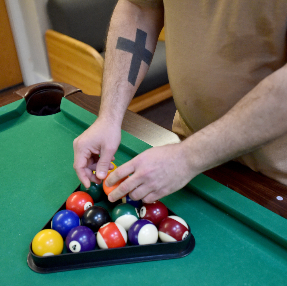 Andrew Zelonis racks the balls for a game of billiards during an evening at the Waterville Social Club on Ticonic Street on Friday. Zelonis said he appreciates the time he spends at the Social Club. "I've made friends and I can do my laundry," he said.