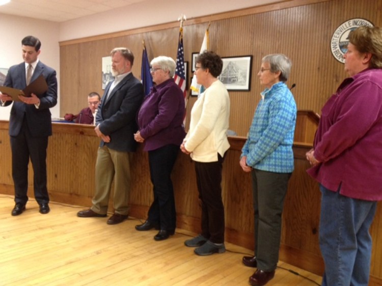 Waterville Mayor Nick Isgro reads a proclamation aloud Tuesday in the council chambers that honors Waterville Food Bank volunteers as the 2016 Spirit of America Volunteers of the Year. At right are Waterville Food Bank President David Dawson, volunteer coordinator Beth Thomas and volunteers Amy Earickson, Emily Atkinson and Arlene Strahan.