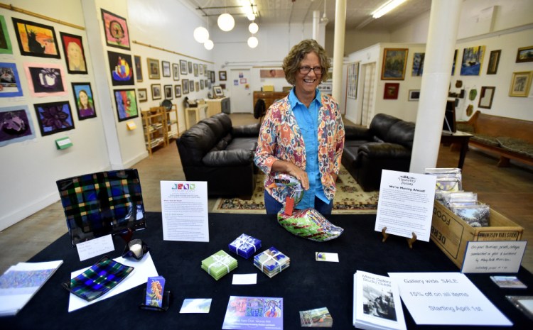 Mardy Bogar smiles as she stands in Upcountry Artists Gallery and Learning Center on Friday in Farmington. The gallery is closing at the end of April.