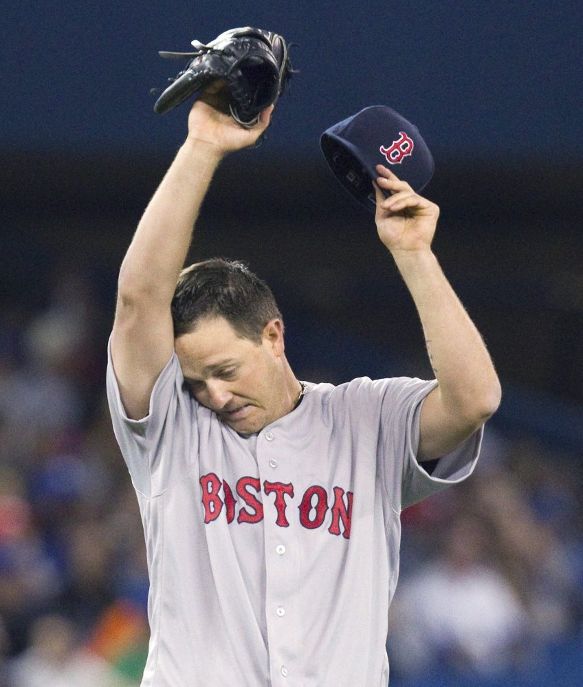 Boston Red Sox starting pitcher Steven Wright wipes his face during the sixth inning against the Toronto Blue Jays on Sunday in Toronto.