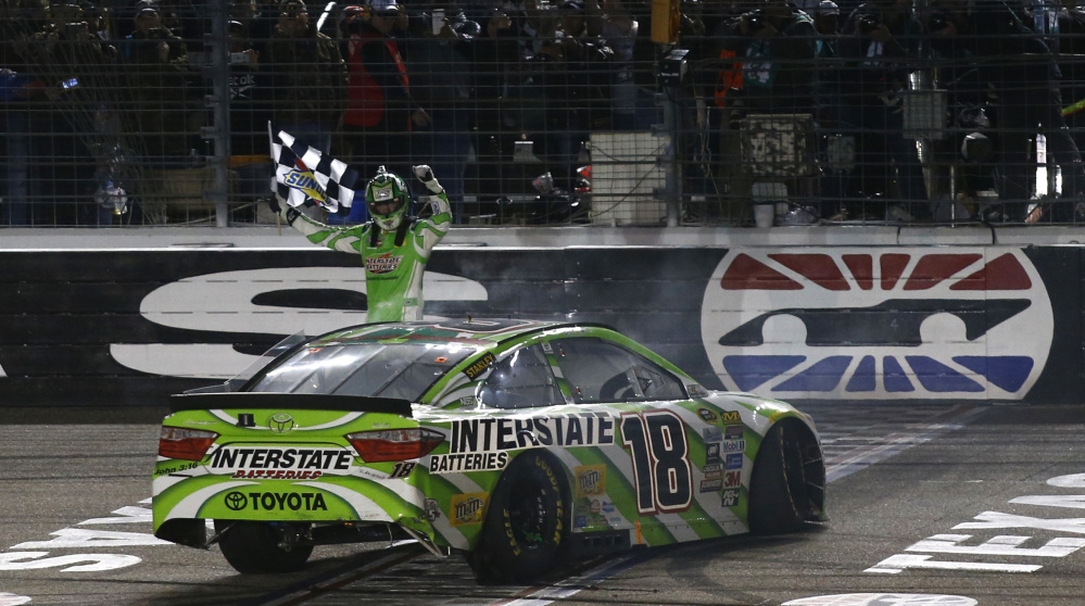 Kyle Busch celebrates after winning the NASCAR Sprint Cup Series auto race early Sunday morning at Texas Motor Speedway in Fort Worth, Texas.