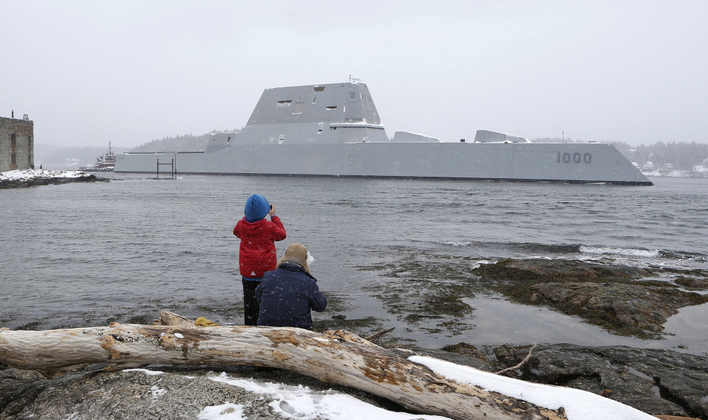 In this March 21 photo Dave Cleaveland and his son, Cody, photograph the USS Zumwalt as it passes Fort Popham at the mouth of the Kennebec River in Phippsburg, as it heads to sea for final builder trials. The ship is so stealthy that the U.S. Navy resorted to putting reflective material on its halyard to make it visible to mariners during the trials.