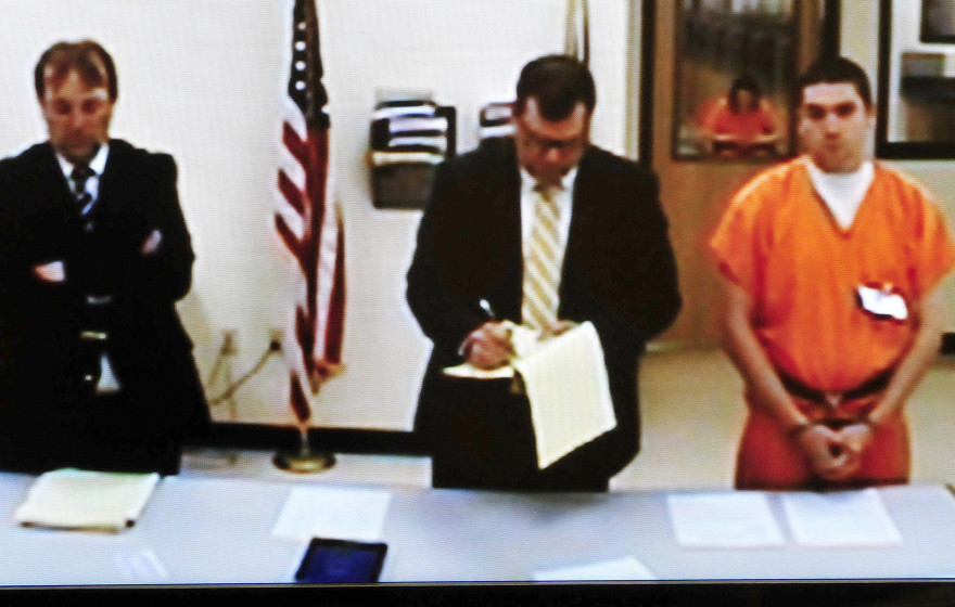 Jeremy Erving, right, listens via video Monday in Skowhegan District Court. At left is Assistant District Attorney Brent Davis, and attorney John Martin is at center. Erving is being held without bail on a murder charge. Police claim he killed his uncle Randy Erving last week in St. Albans.