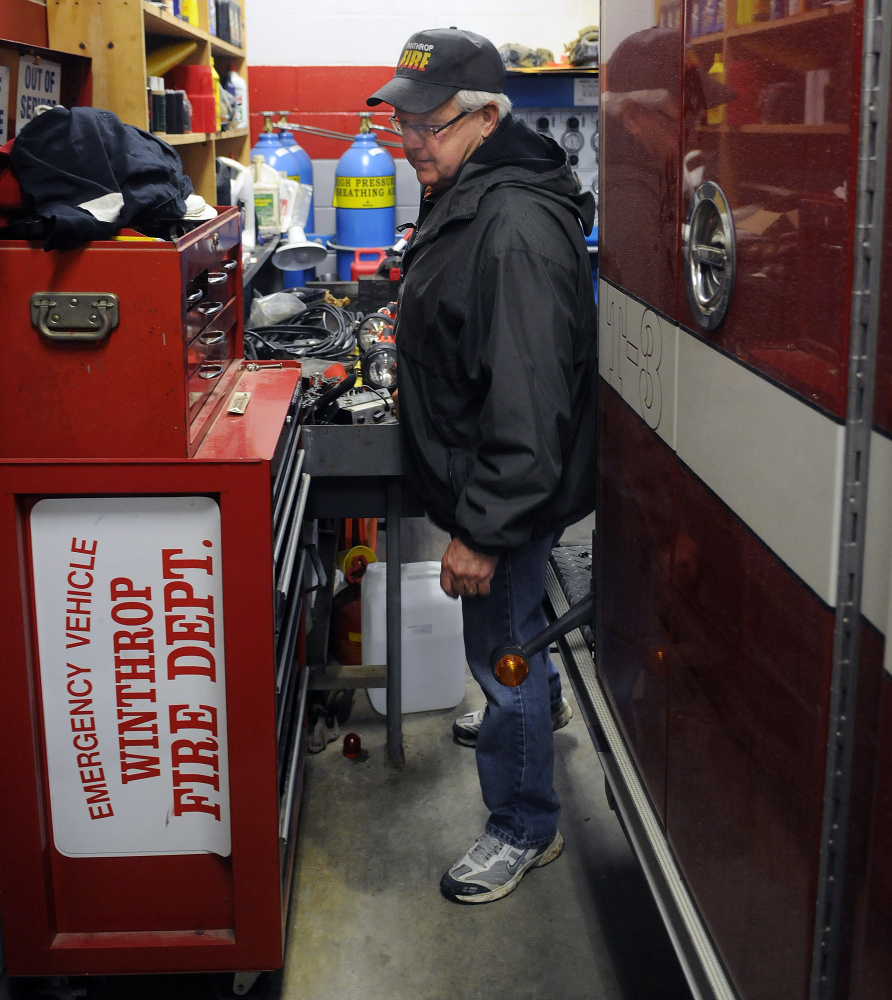Winthrop Fire Department Deputy Chief Dave Currie squeezes between a work area and an engine Tuesday at the town's fire station. Winthrop is looking to replace the firehouse with a new facility.