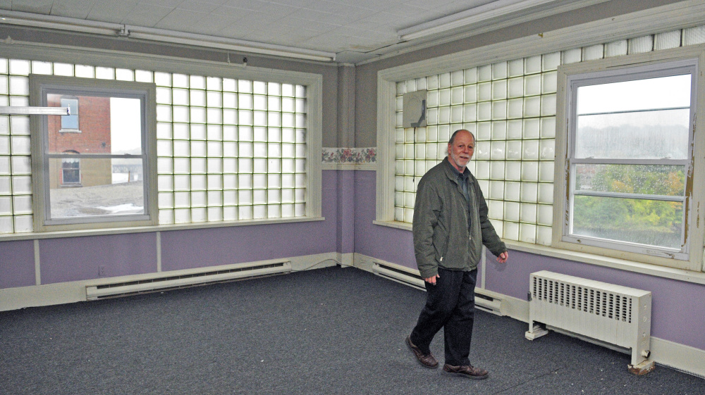 Developer Richard Parkhurst talks in 2015 about the view of the Kennebec River from the windows on fourth floor of 287 Water St. Parkhurst has asked the city for a tax increment financing plan to help pay for improvements to the building.