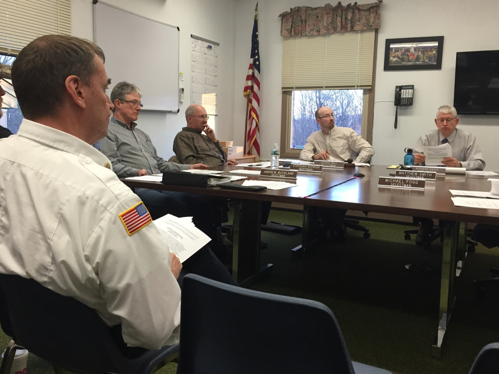 Fire Chief Terry Bell sits in front of the Farmington Board of Selectmen on Tuesday night as the board decides to postpone the hiring of two full-time firefighters because a nepotism clause in the town's hiring policy makes them ineligible.