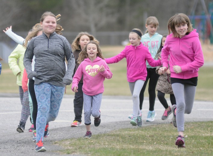 Gilbert Elementary School students run through Augusta after school Monday as part of Girls on the Run, a national program that promotes physical activity and positive youth development.