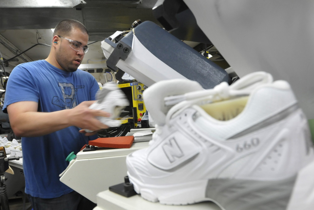 Justin Waring lays souls on shoes at New Balance in Norridgewock Monday,  May 9, 2011.