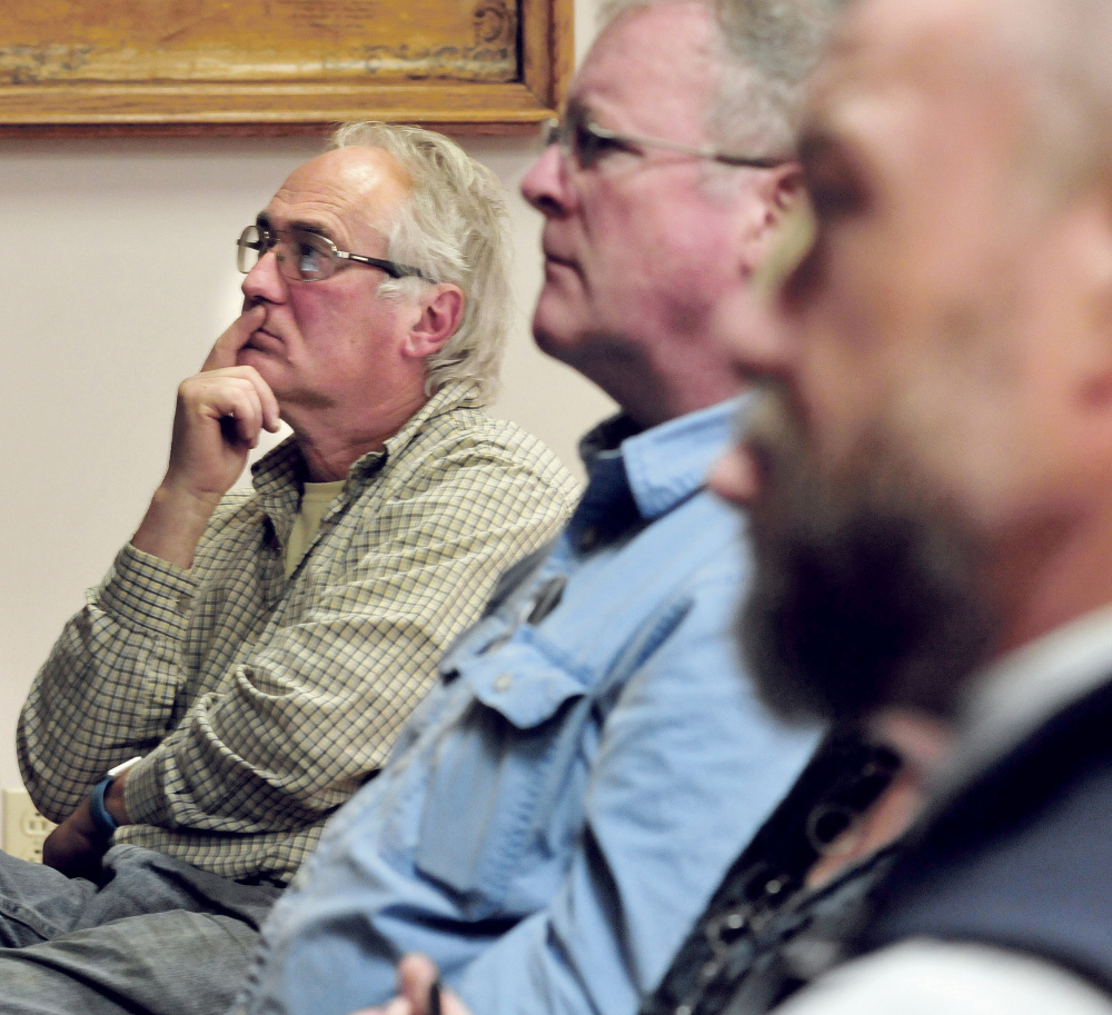 Waterville Concourse business owner Ken Vlodek, left, listens to a discussion Wednesday about revitalization of downtown Waterville.