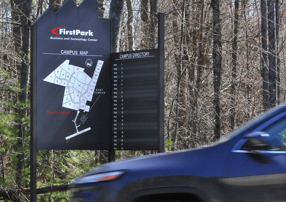A motorist passes a FirstPark directory sign Thursday at the business park in Oakland. The park is aiming to attract small and medium-sized companies to its remaining lots while a global real estate firm works to identify developers to construct buildings there.