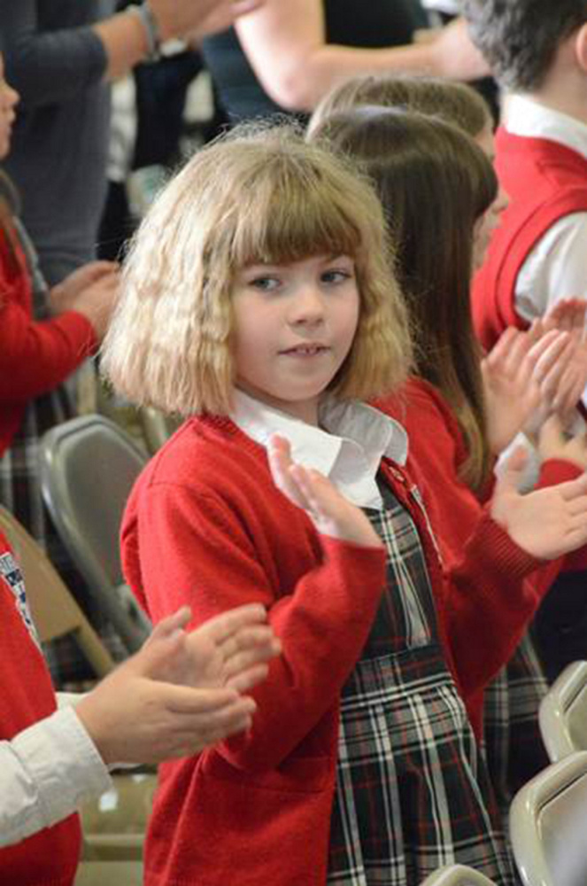 Annie Veilleux, a student at Mount Merici Academy in Waterville, during Bishop P. Deeley's visit April 13 to the school.