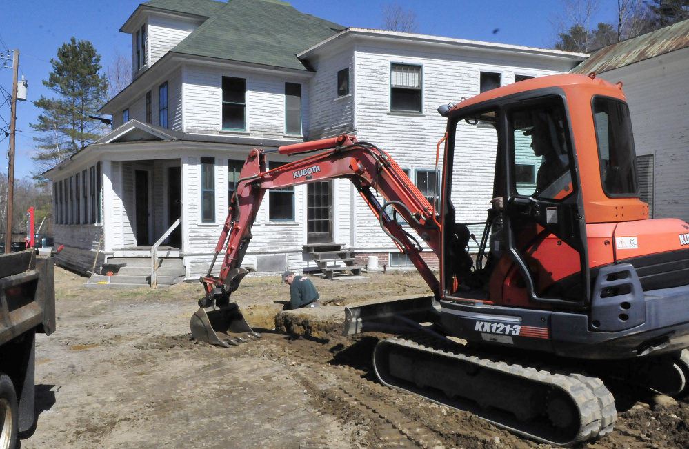 Craig Hutchinson digs a trench as volunteer Steve Mitchell shovels soil beside the proposed Western Maine Play Museum in Wilton on Wednesday.