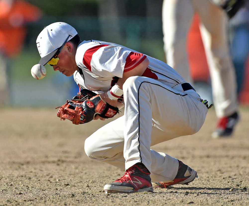 Thomas College second baseman Aron Smestad gets eaten up by a groundball against New England College on Saturday at Thomas College in Waterville.