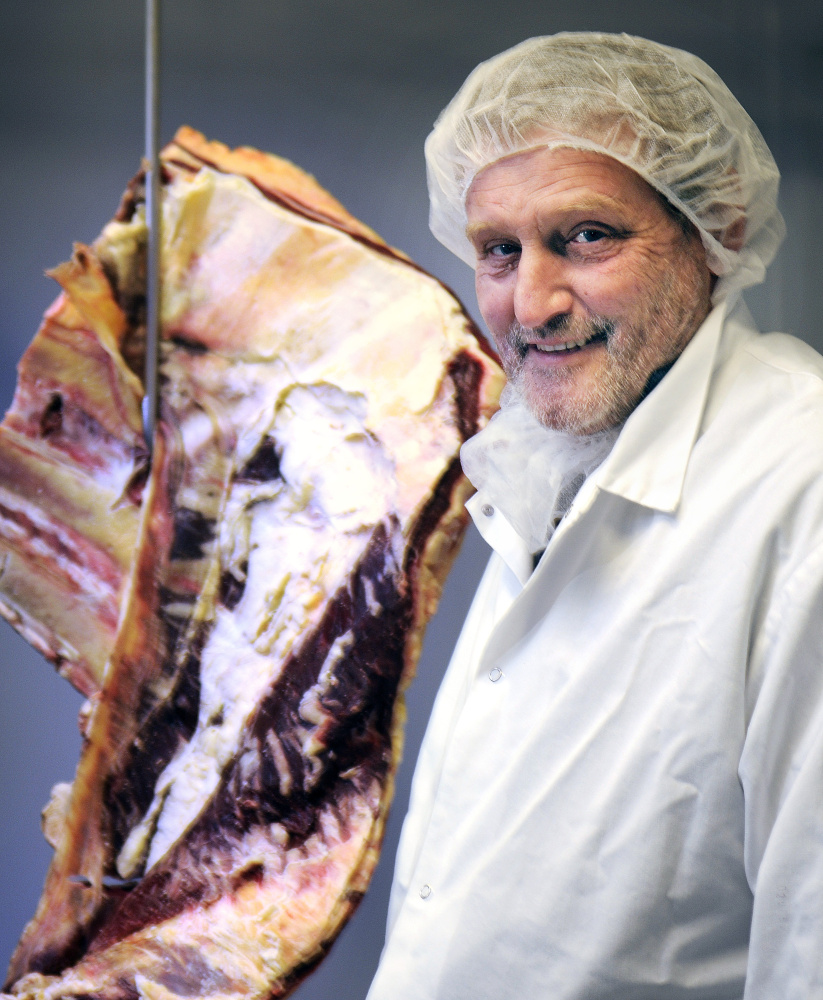 Central Maine Meats partner Bill Lovely with a cut at the firm's processing plant in Gardiner on Monday.