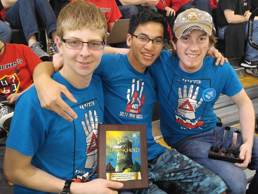 Hall-Dale High School's REM Delta Prime Robotics team members Isaac Lawrence, Ean Smith, and Colt Siegars celebrate after winning the Gracious Professionalism award at a FIRST robotics competition in Providence, Rhode Island, in March.