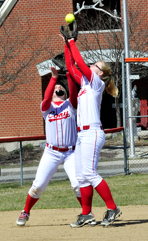 Cony's Alexis Couverette, left, and Autumn Sudsbury field a fly ball against Skowhegan on Wednesday in Skowhegan. Sudsbury made the catch.