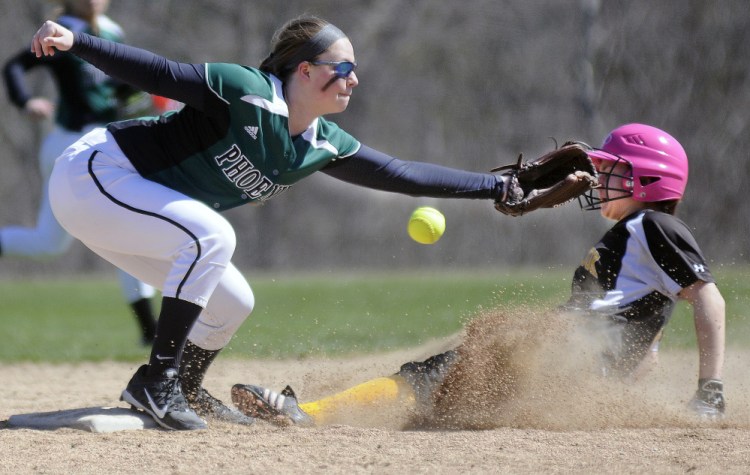 Maranacook's Justine Merrill slides under the attempted tag by Spruce Mountain's Haley Turcotte at second base during a softball game Wednesday in Readfield.
