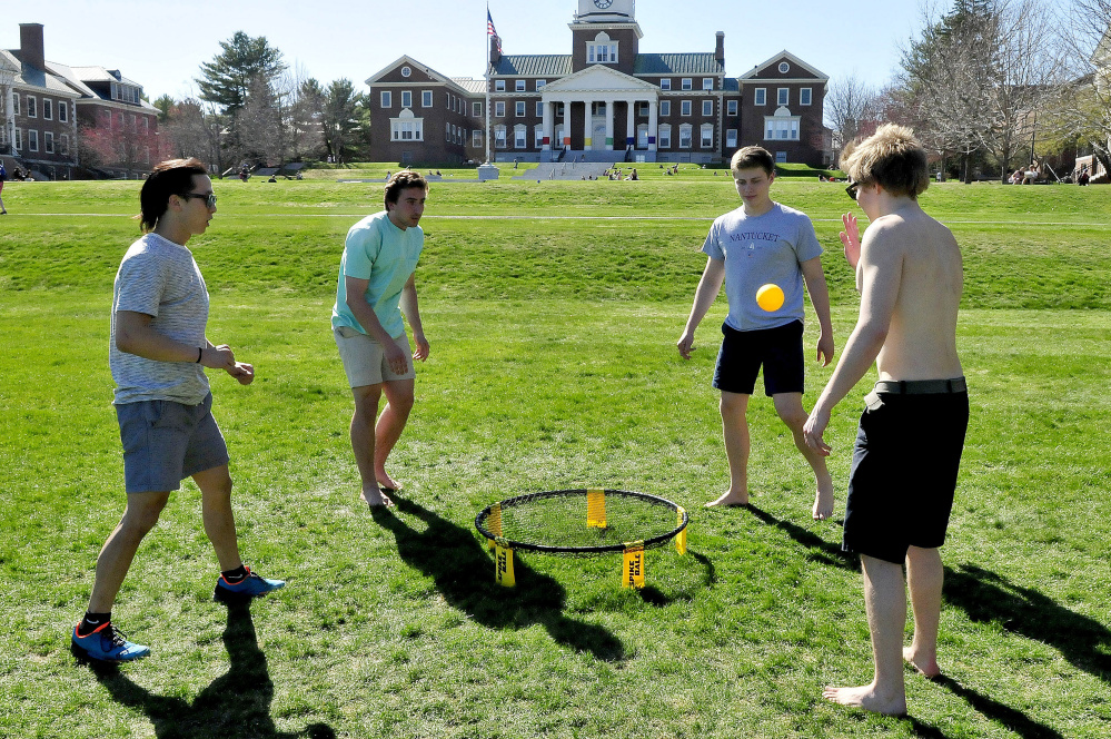 Colby College students, including this group playing spike ball, studied, relaxed and played outdoors during one of the warmest days of spring on Thursday. The college will celebrate Earth Day today with a fair featuring a clothing recycling event and T-shirt creations, and on Saturday with a concert and carnival.