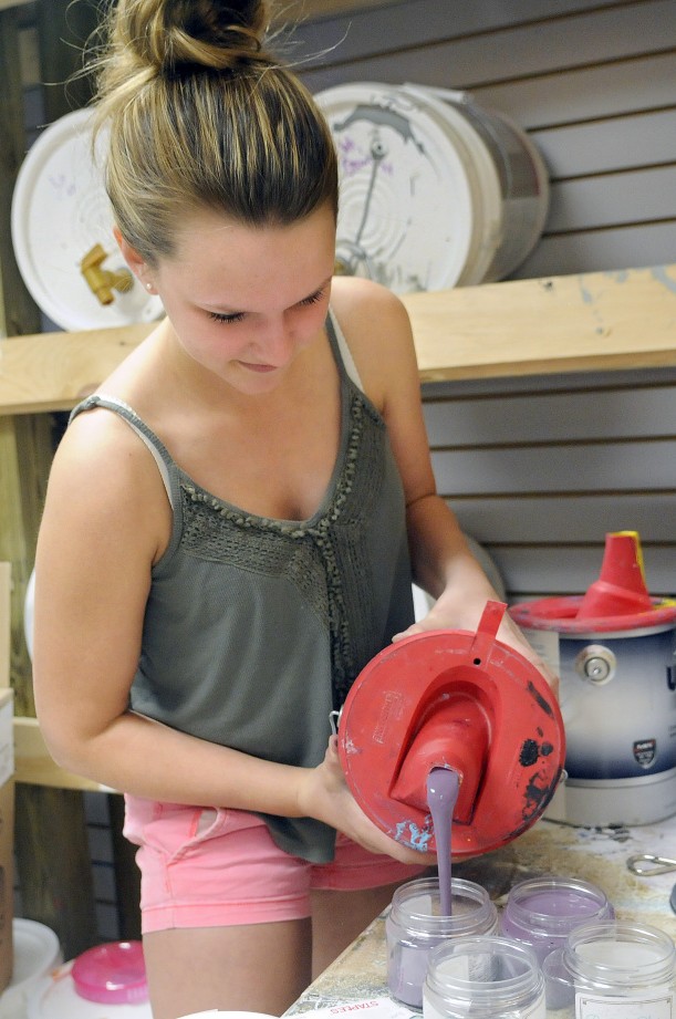 Abby Hoffay pours paint into jars Thursday at Chalky & Co. in Monmouth.
