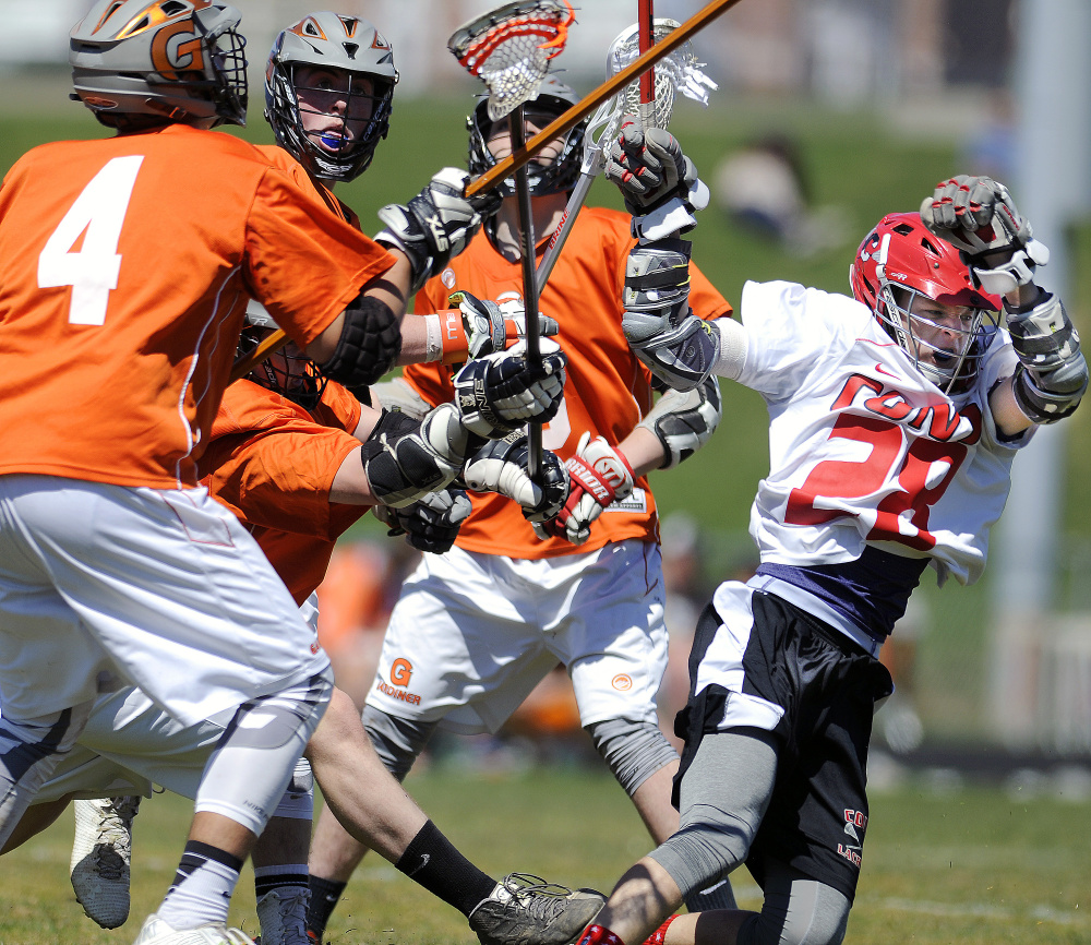 Cony High School's Dalton Bowie, right, is surrounded by Gardiner Area High School players during a boys lacrosse game Thursday in Augusta.