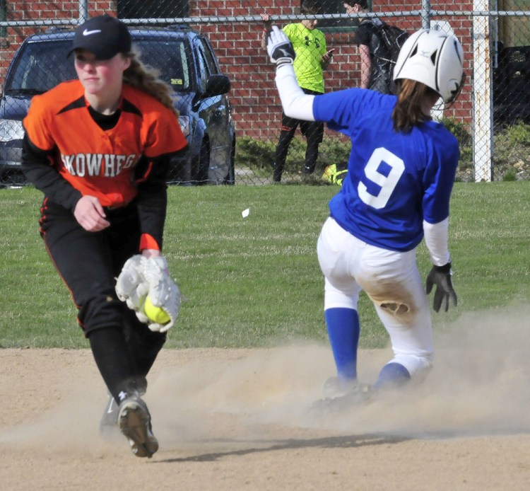 Skowhegan infielder Wylie Bedard fields ball as Messalonskee runner Madisyn Charest slides safely into second base during a Kennebec Valley Athletic Conference Class A game Monday afternoon.