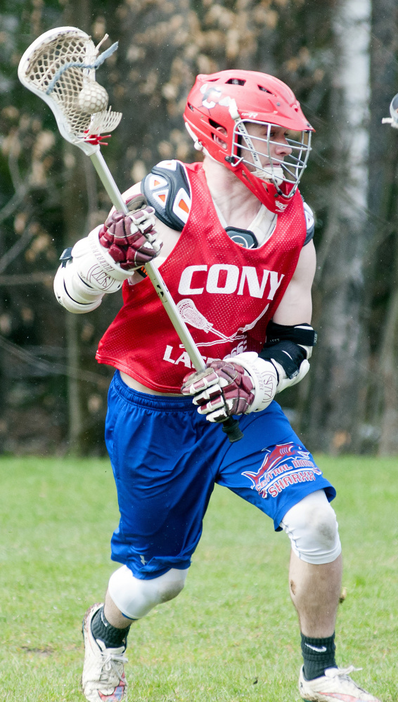 Tyler Sproul runs with the ball during lacrosse practice Tuesday at Cony High School in Augusta.