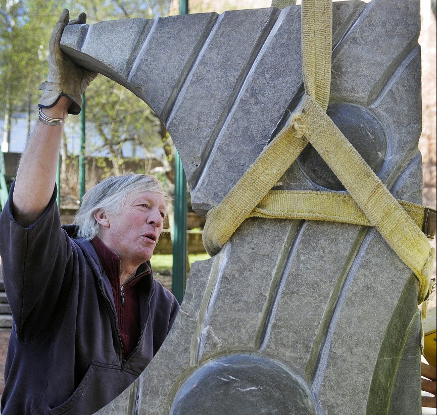 Sculptor Bill Royall installs "Galaxy," a carved stone sculpture, on Wednesday at Johnson Park in Gardiner.