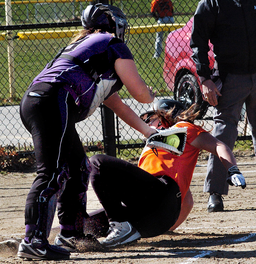 Waterville catcher Coby Dangler attempts to tag out Gardiner's Maddie Curran at home plate during game Wednesday in Waterville.
