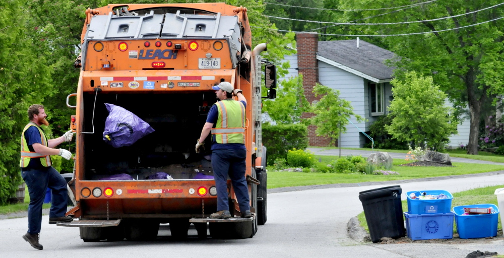 Waterville Public Works employees pick up trash last summer in Waterville. The city's solid waste committee has recommended that the city take its trash to the Crossroads landfill in Norridgewock after its contract with the Penobscot Energy Recovery Co. ends in 2018.