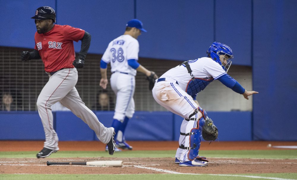 Boston's Jackie Bradley Jr. scores on an RBI double by Josh Rutledge while while Blue Jays' catcher Josh Thole waits for the throw during the Red Sox' 7-4 win in an exhibition game Saturday in Montreal.