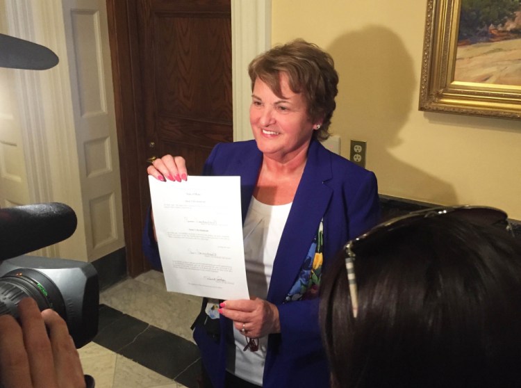 Sen. Susan Deschambault, D-Biddeford, poses with the oath of office she and the governor signed Tuesday. Gov. Paul LePage had canceled her swearing-in ceremony scheduled Friday because of a political dispute with Democrats.