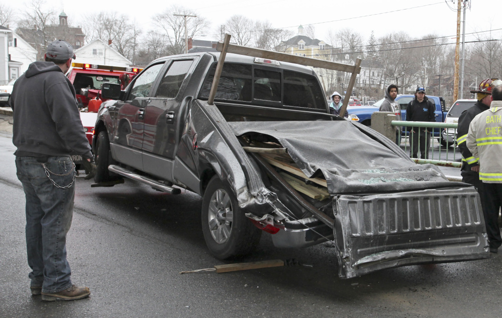Roy Ordway's pickup is hooked to a tow truck after the crash. He didn't mind the damage – he was planning to buy a van.