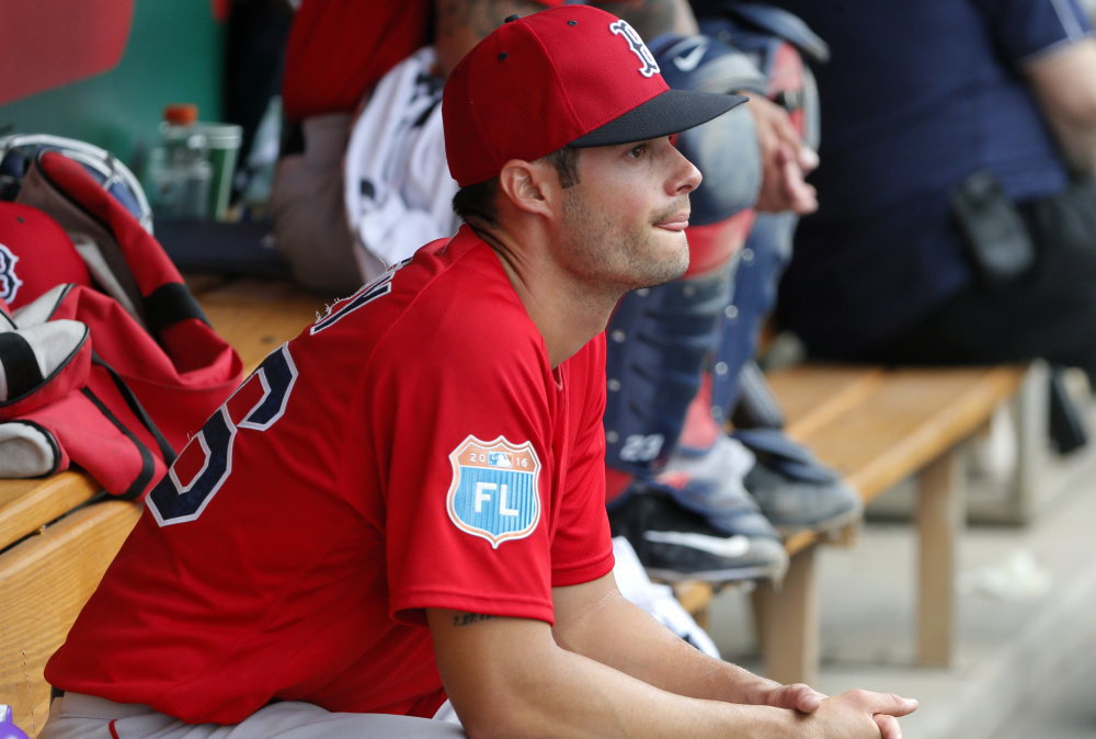 Boston Red Sox's Joe Kelly sits in the dugout in the third inning of a spring training baseball game against the Minnesota Twins on Tuesday, March 29, 2016, in Fort Myers, Fla. (AP Photo/Tony Gutierrez)