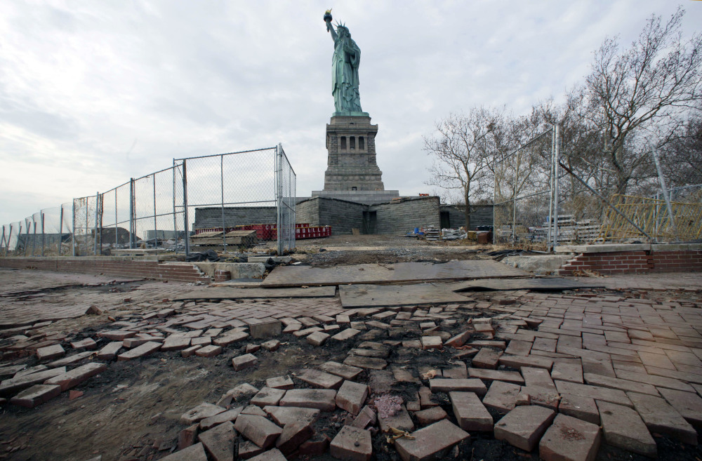The Statue of Liberty stands beyond parts of a brick walkway damaged in Superstorm Sandy on Liberty Island in New York.