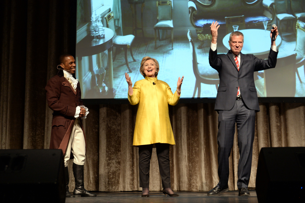 Leslie Odum Jr., left, from the Broadway musical "Hamilton," presidential candidate  Hillary Clinton, center, and New York City Mayor Bill de Blasio, right, perform at the 94th annual Inner Circle Dinner at the New York Hilton Hotel in Manhattan.