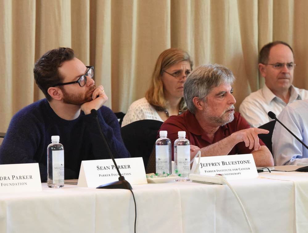 From left, Sean Parker and Jeffery Bluestone at the Parker Institute for Cancer Immunotherapy Scientific Retreat in St. Helena, Calif., describe their project to speed development of cancer-fighting drugs that harness the immune system.