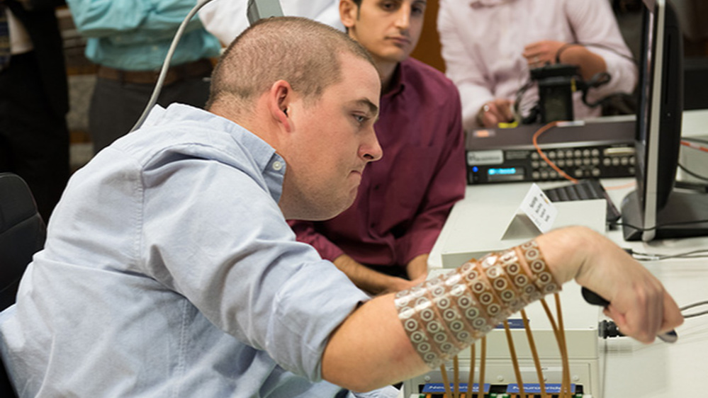 Ian Burkhart participates in a study with neural bypass technology at The Ohio State University Wexner Medical Center in Columbus. A computer chip in Burkhart's brain reads his thoughts, decodes them, then sends signals to a sleeve on his arm that allows him to move his hand.