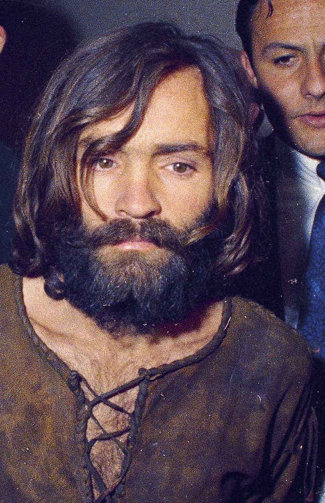 Charles Manson is escorted to his arraignment on conspiracy-murder charges in connection with the Sharon Tate murder case in 1969 in Los Angeles, Calif. 