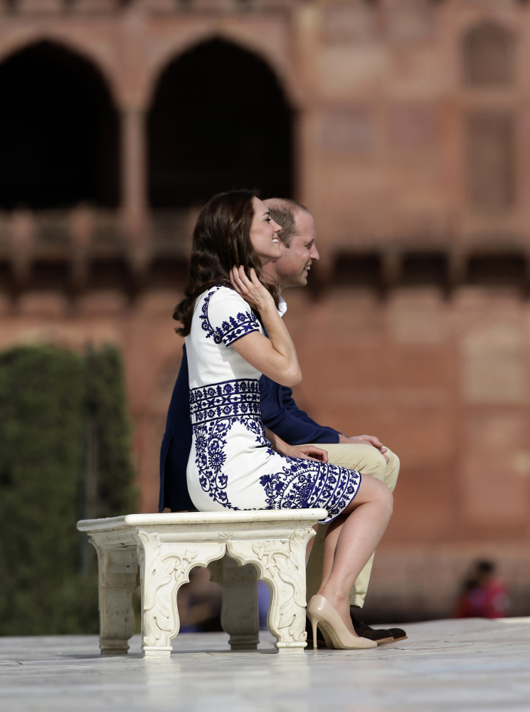 Britain's Prince William, along with his wife, Kate, the Duchess of Cambridge, pose for photographers on the same bench where the prince's mother, Princess Diana, famously posed in front of the Taj Mahal in Agra, India, on Saturday.
