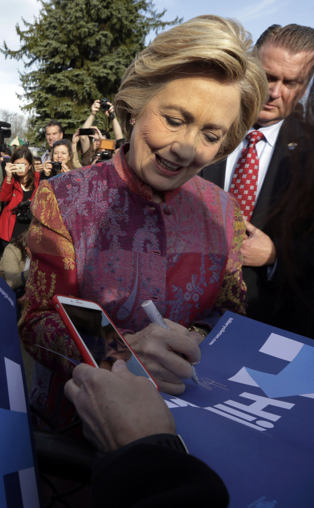 Hillary Clinton signs autographs after voting in Chappaqua, N.Y., Tuesday. The nation's attention on Donald Trump has cloaked her perception troubles.