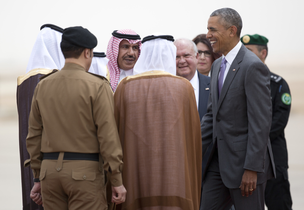 President Barack Obama is greeted as he arrives on Air Force One at King Khalid International Airport in Riyadh, Saudi Arabia.