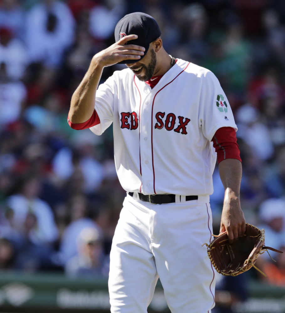 Boston Red Sox starting pitcher David Price tugs down on the brim of his cap while walking to the dugout after being pulled during the fourth inning of an MLB baseball game against the Tampa Bay Rays in Boston, Thursday, April 21, 2016. Price gave up six runs in the fourth. (AP Photo/Charles Krupa)