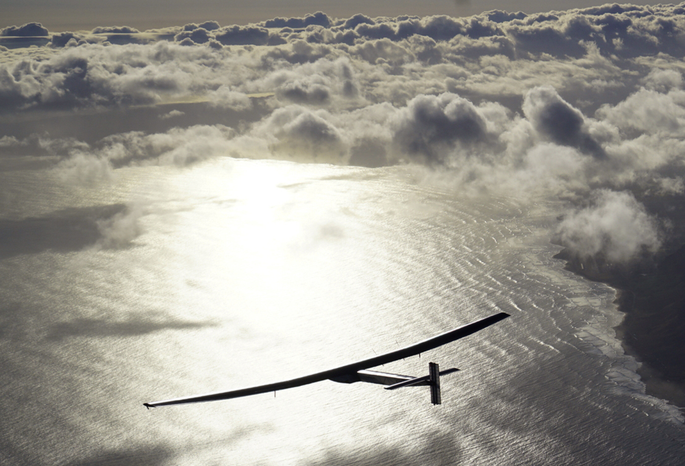 The solar-powered plane Solar Impulse 2, piloted by Bertrand Piccard, is seen in the air after taking off from Hawaii.