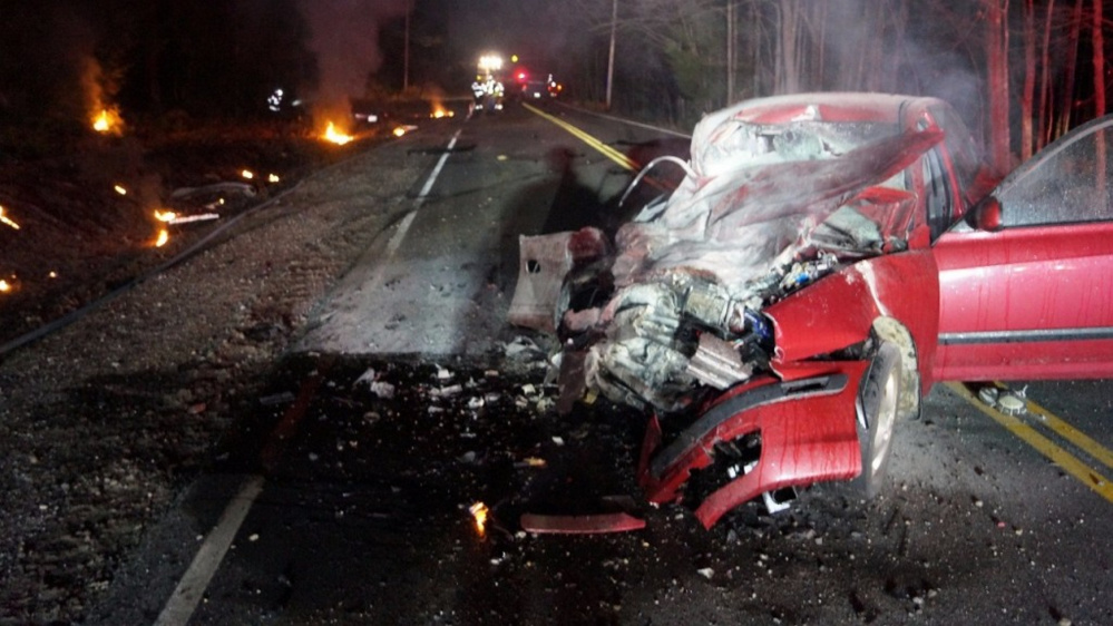 The wreckage of a Hyundai sedan sits in the middle of Route 118 in Norway. The car’s driver, Jennifer Clough, 42, of Norway, was injured when another vehicle struck her car head-on late Friday and it burst into flames.
Photo courtesy WSCH-TV 6.