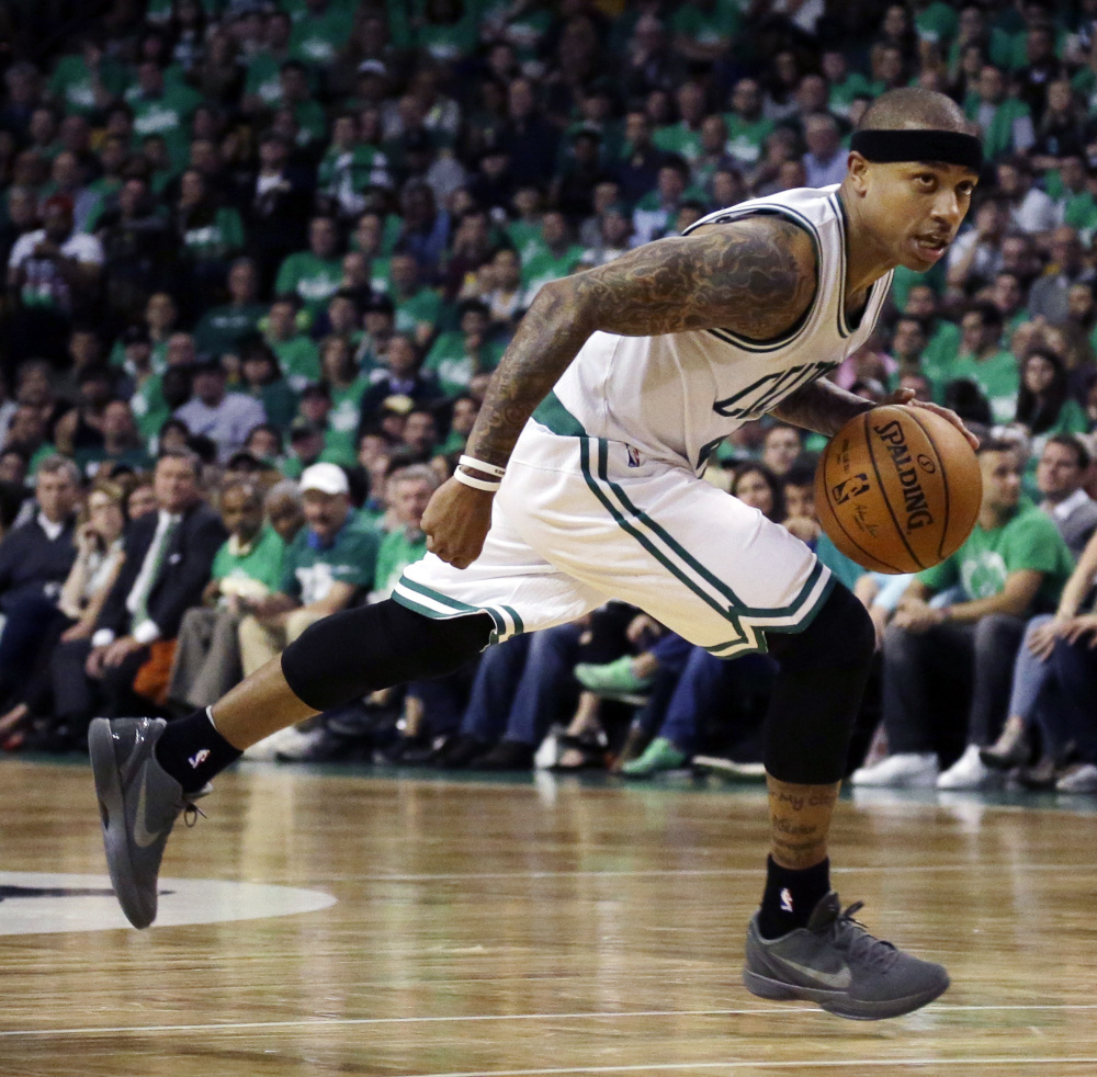 Celtics guard Isaiah Thomas dribbles the ball against the Atlanta Hawks during the third quarter in Game 3 of a first-round NBA playoff series Friday in Boston. The Celtics won 111-103. Thomas finished with a career-high 42 points. 
The Associated Press