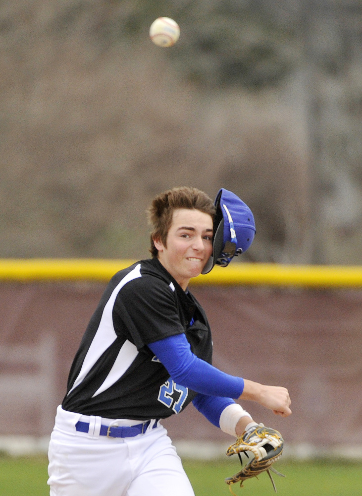 Kennebunk second baseman Derek Smith loses his cap while making a throw to first base for an out.