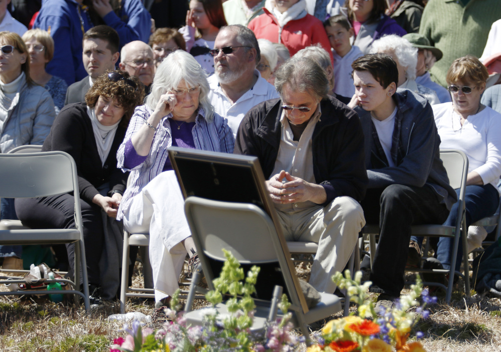 Adam Perron's parents, Dianne Parker and Jeff Perron, listens to speakers Sunday at a memorial service for their son in Naples.
