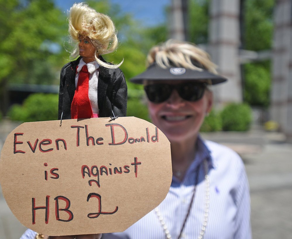 Nancy Hight shows off her Donald Trump doll Monday in Raleigh, N.C. House Bill 2 blocks local and state protections for lesbian, gay, bisexual and transgender people.