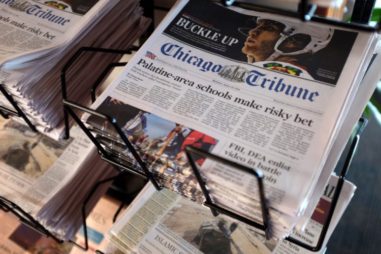 Chicago Tribune and other newspapers are displayed at Chicago's O'Hare International Airport on Monday.