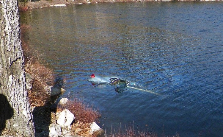 A car sinks in Fox Pond in Hancock County on Saturday. Maine State Police photo